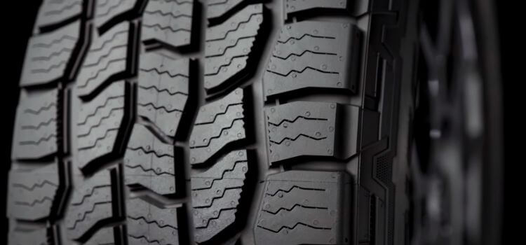Close-up view of Cooper Discoverer AT3 4S tire, revealing detailed tread pattern and quality craftsmanship.