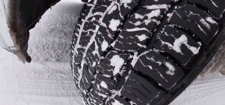 Close-up of Cooper Discoverer AT3 4S tires after driving over snow, highlighting winter performance and snow-traction capabilities.