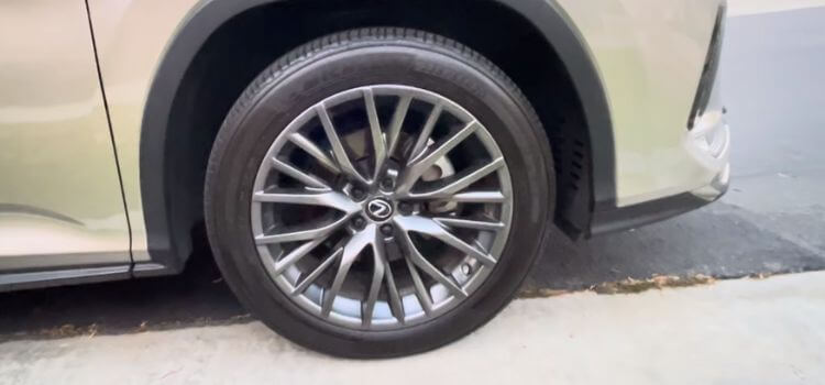 2024 Lexus RX showcasing Michelin Defender 2 tires, elegantly navigating a smooth paved road."